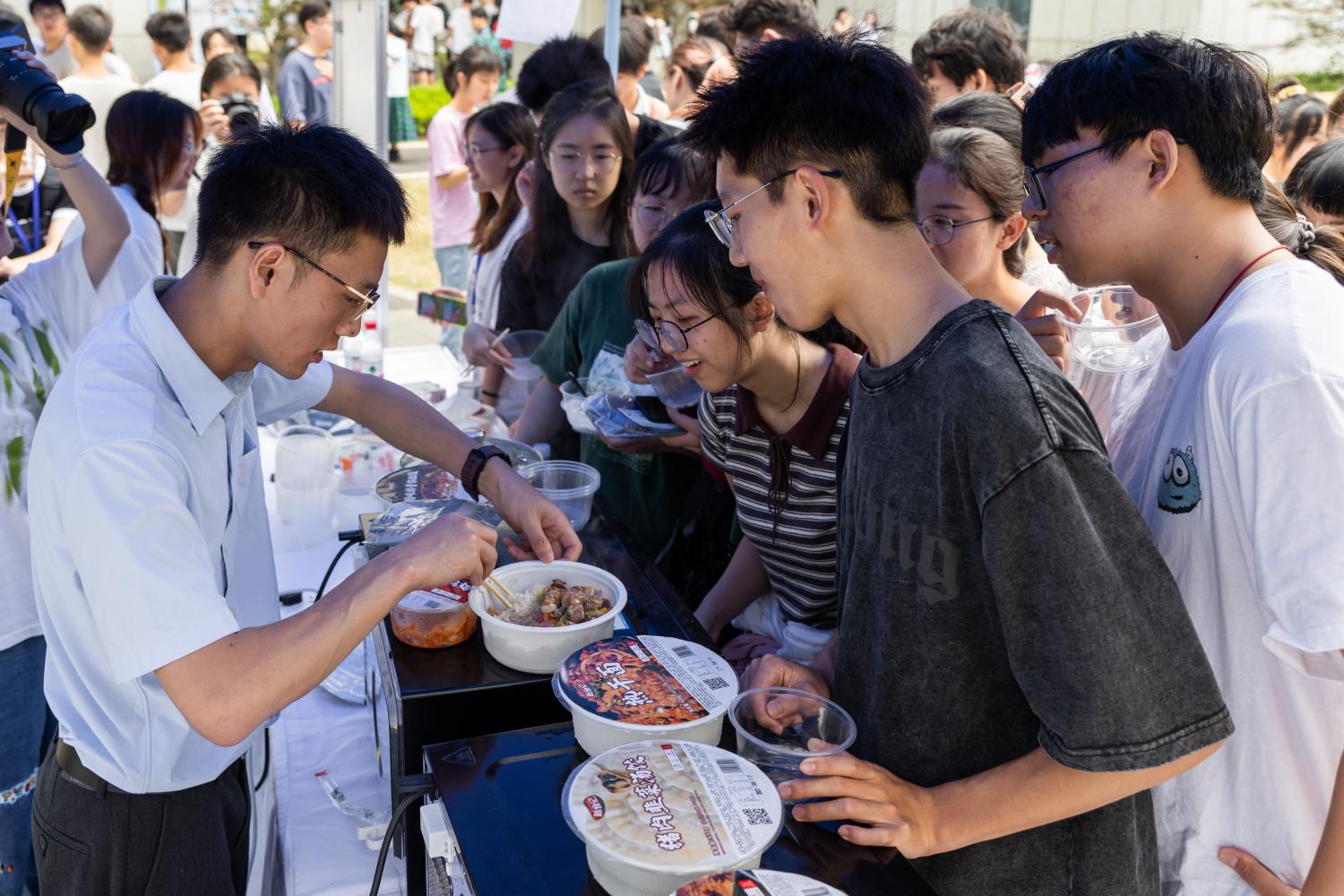 <p>同学们感受刚出炉的鲜食产品（学通社记者 周全 摄）</p>